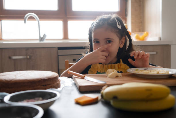 istock Cute girl making a cake 1472036124