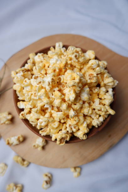 istock Sweet caramel pop corn in a wooden bowl 1472038299