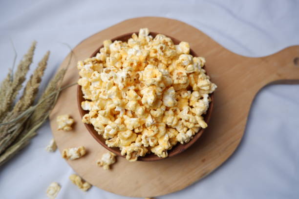 istock Sweet caramel pop corn in a wooden bowl 1472038303