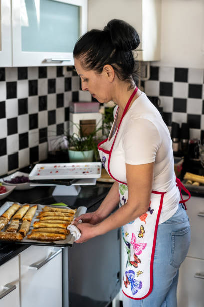istock A young female is finished baking vegetable rolls. 1472039341