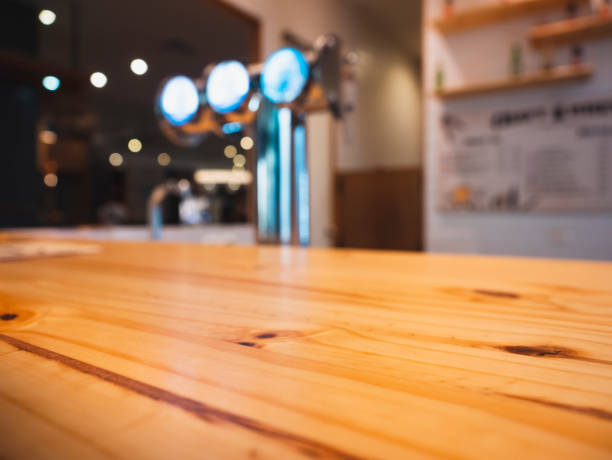 istock Table top counter bar with beer tab blur background 1472042018