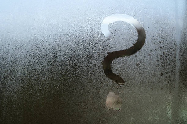istock Fogged glass, a question mark is written on the window with condensation, texture on the glass with condensation. 1472042440