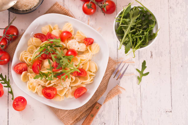 istock Orecchiette pasta with arugula and tomato. 1472044281