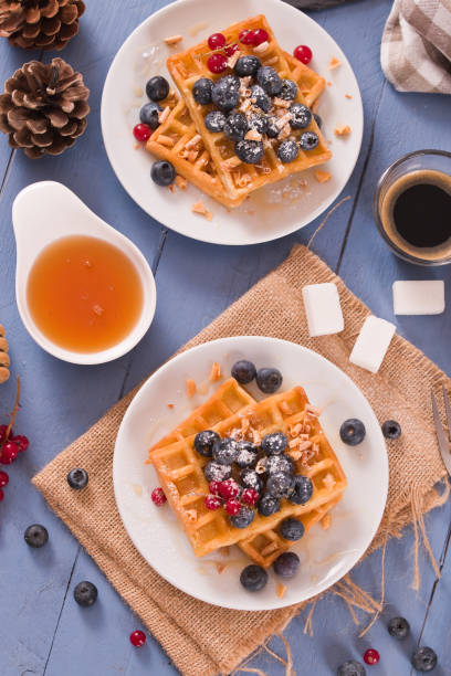istock Waffles with red currant and blueberries on white dish. 1472044313