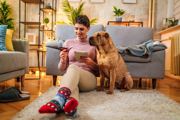 istock Cheerful woman using tablet for online shopping 1472045406