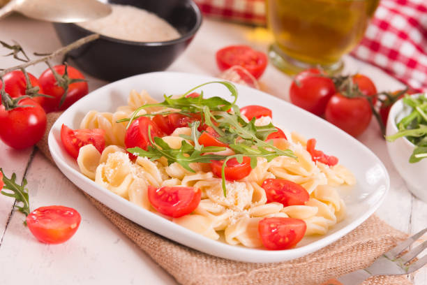 istock Orecchiette pasta with arugula and tomato. 1472045543