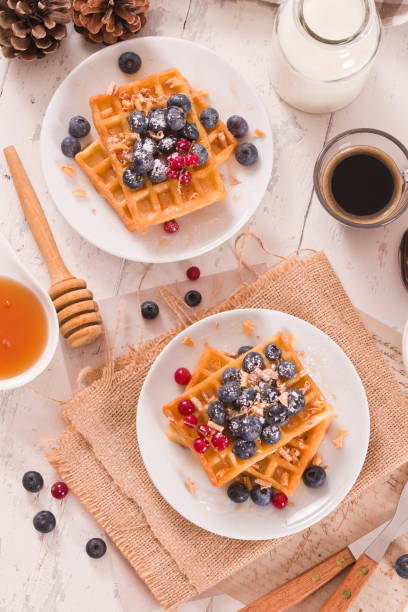 istock Waffles with red currant and blueberries on white dish. 1472046007