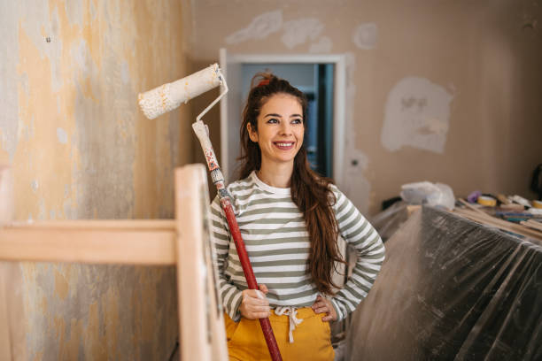 istock Woman painting a wall 1472046337