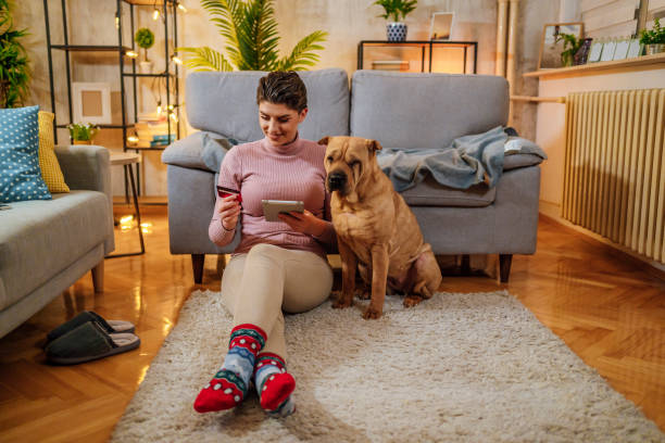 istock Cheerful woman using tablet for online shopping 1472047528