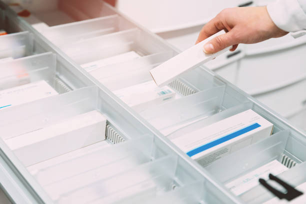 Close up of pharmacist hand taking medicine from drawer