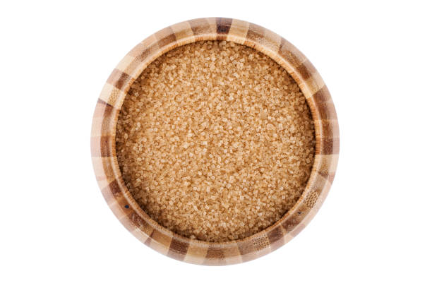 istock Wooden bowl with brown sugar isolated on white background 1472049469