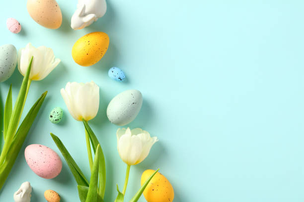 istock Happy Easter card template. Flat lay composition with colorful Easter eggs, tulips flowers, decorative Easter bunny. 1472050988