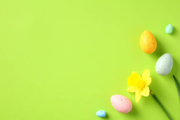 istock Happy Easter green background with daffodil flowers and colorful Easter eggs. 1472051315