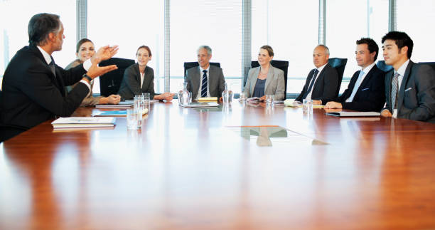 Business people meeting at table in conference room  formal businesswear stock pictures, royalty-free photos & images