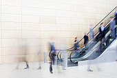 Business people on escalators