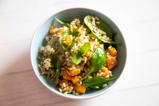 istock Delicious rice salad with pumpkin and spinach 1472054011