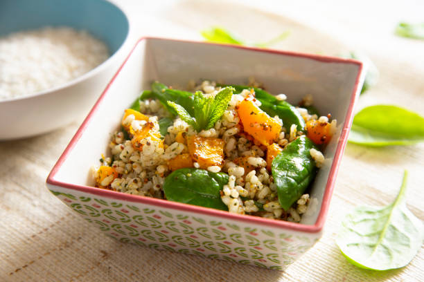 istock Delicious rice salad with pumpkin and spinach 1472054041