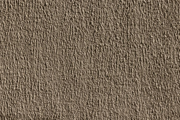 A closeup view of a beautifully crafted beige wall that showcases subtle patterns and boasts a smooth texture