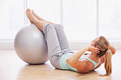 Woman doing sit-ups with fitness ball