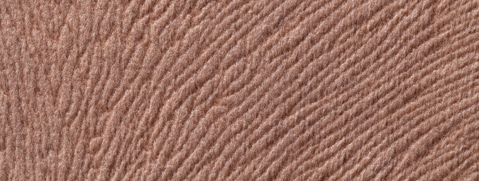 Texture of dark brown textile background from a soft wool material, macro. Fabric with umber wavy pattern. Cloth upholstery backdrop. Light brown background from a soft wool textile material closeup. Fabric with natural texture. Cloth backdrop.