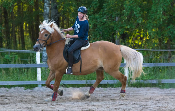 istock Woman horseback riding 1472057164