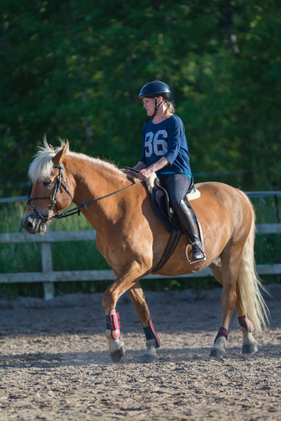 istock Woman horseback riding 1472057173