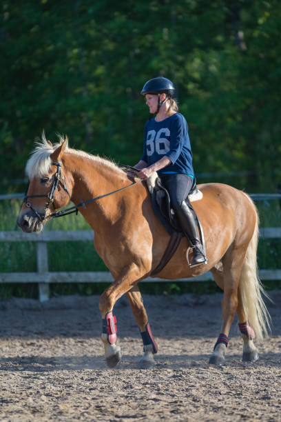 istock Woman horseback riding 1472057193