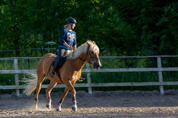 istock Woman horseback riding 1472057195