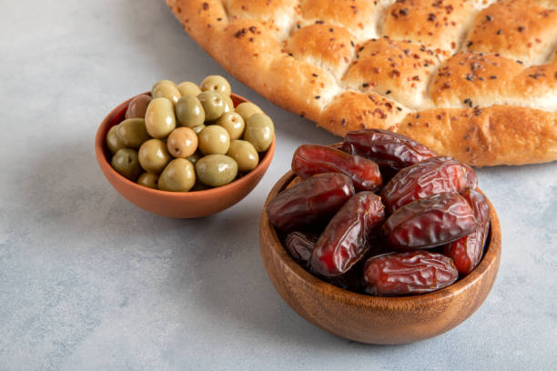 istock Ramadan pita, dates fruit and green olives.Islamic iftar table 1472057701