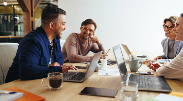 istock Advertising professionals having a meeting in a boardroom 1472058292