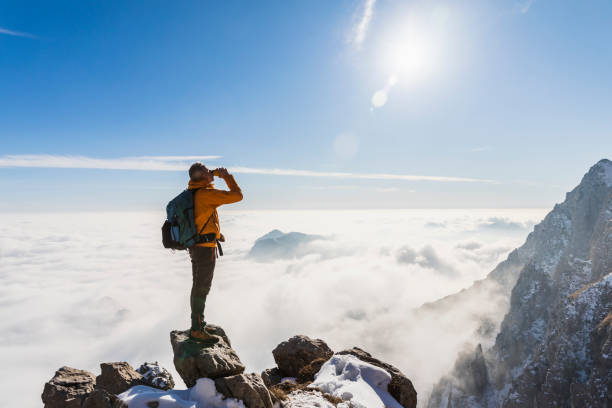 istock hiker in high mountains drinking from water bottle 1472059517