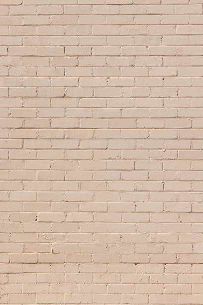 istock Part of a painted old beige brick wall 1472059564