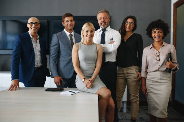 istock Successful and diverse business team standing together in an office 1472060083