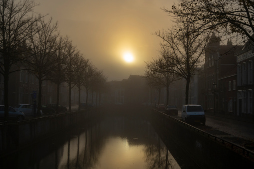 Kampen Burgel city canal during a foggy morning in the city in Overijssel, The Netherlands