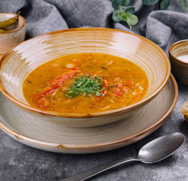 istock Traditional chicken noodle soup in a brown bowl 1472062102