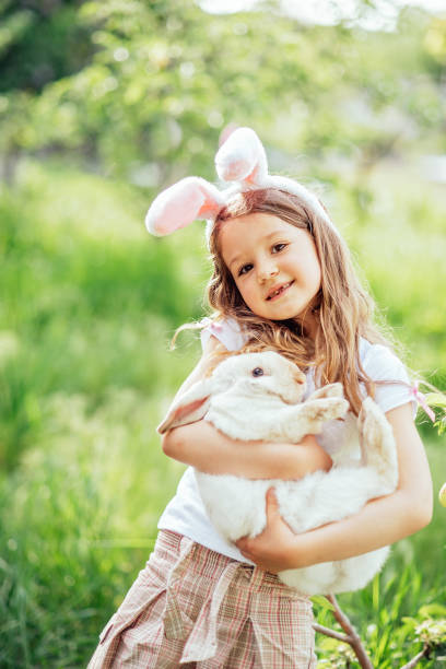 istock Baby with basket full of colorful eggs. Easter egg hunt. 1472070582