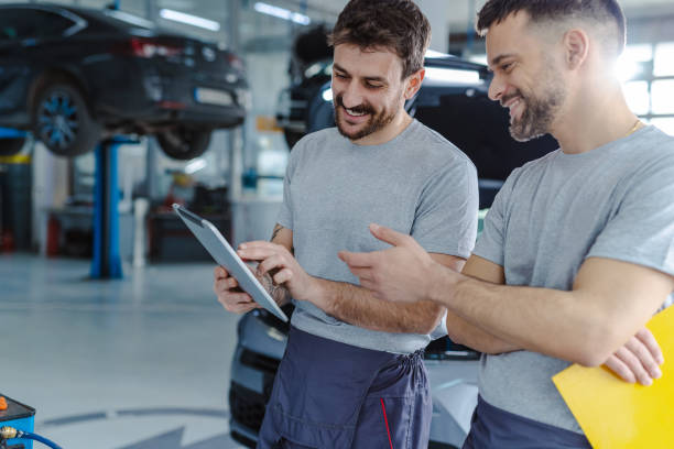 istock Automotive technicians working together at the service station 1472075811