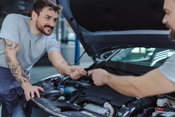 istock Skilled automotive technicians repairing the client car 1472075813