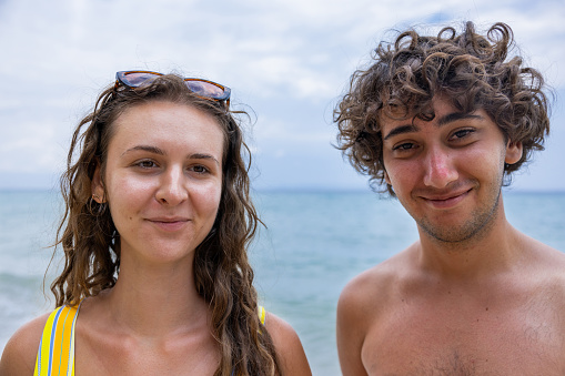 Portrait of the young Caucasian couple on the beach, enjoying their vacation