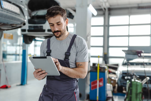 istock Automotive technician at the service station checking tasks on a digital tablet 1472076777