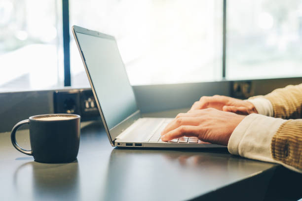 istock caucasian hands working in laptop in a cafe 1472079750