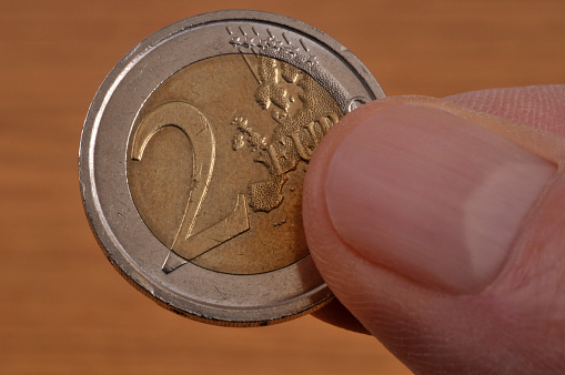Two euro coin in hand close up