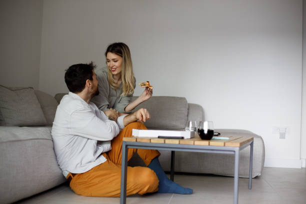 istock Couple enjoying eating pizza 1472081323