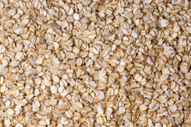 istock Heap of dry rolled oats isolated 1472081823