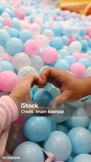istock Love hand symbol with tons of balls 1472085698