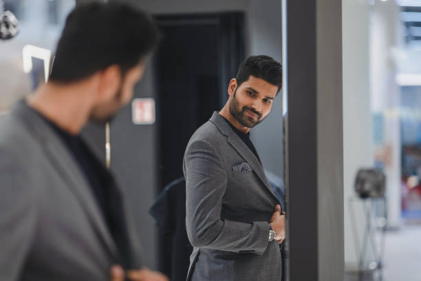 istock Young man shopping in clothing store 1472087359