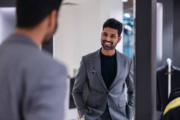 istock Young man shopping in clothing store 1472087418