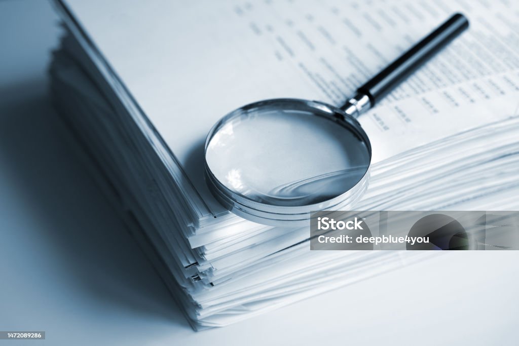 Magnifying File Magnifying Glass On A Stack Of Documents Stock Photo - Download Image ...