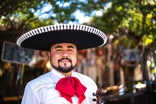 Portrait of mid adult man traditional mariachi outdoors