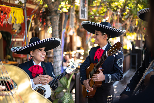 Teenage boys traditional mariachis talking outdoors